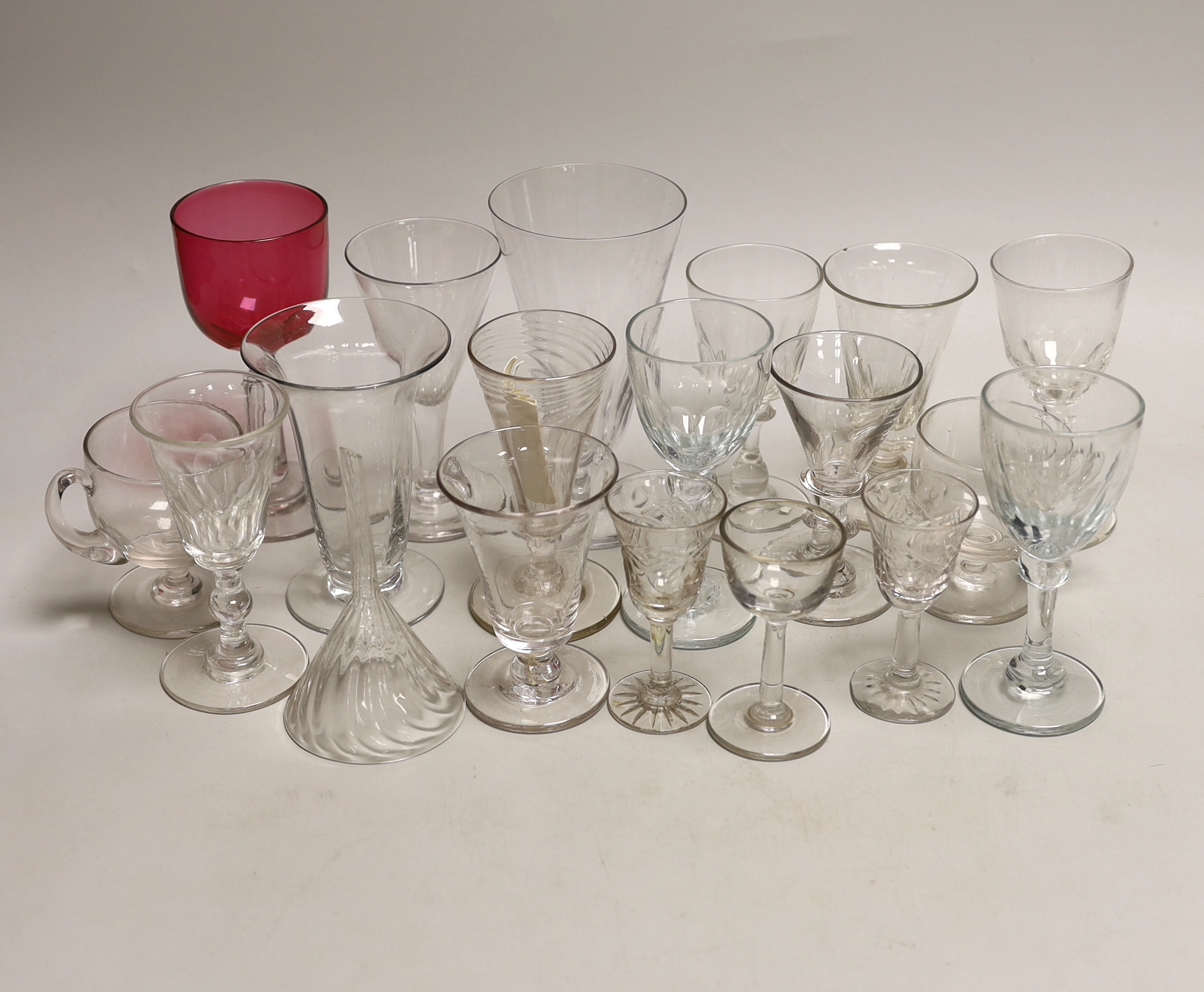 A quantity of antique and later glasses including a Georgian dwarf ale glass and Victorian cranberry example the largest 14cm high